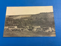 Cartolina postale italiana d'epoca coloniale con veduta panoramica del uadi e delle fortificazioni di Beni Ulid in Libia.