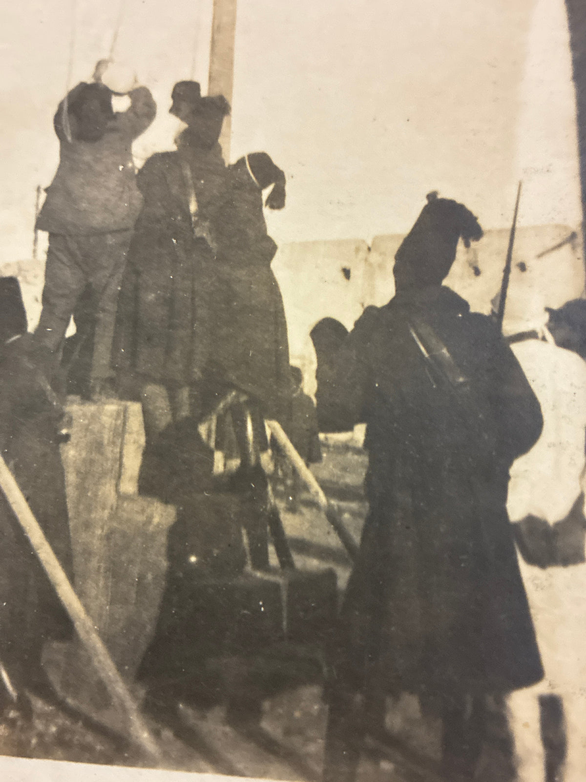 Cartolina fotografica d'epoca coloniale con scena di impiccagione pubblica in Libia e militari italiani di guardia.