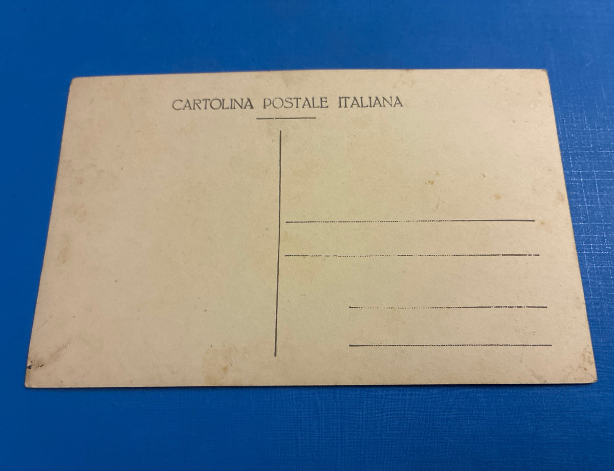 Cartolina postale italiana d'epoca coloniale del 1919 con veduta panoramica di Beni Ulid in Libia e carovana di dromedari che attraversa il uadi.
